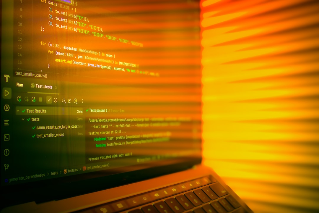 laptop-screen-displaying-code-with-orange-glow-e0sp7dk0dtw